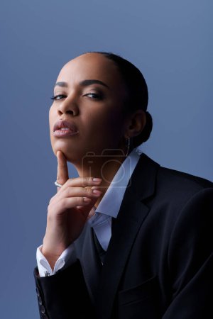 A young African American female model in a business suit posing for a professional portrait.