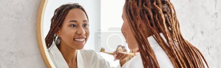 An African American woman with afro braids brushes her teeth in a modern bathroom, focusing on her beauty and hygiene.