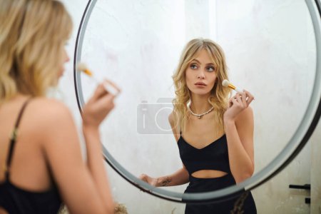 Applying makeup in mirror reflection