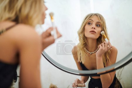 Une femme se brosse les cheveux devant un miroir dans un appartement.