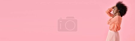 Photo for Banner, african american woman in peach blouse, midi skirt and neck scarf posing on pink backdrop - Royalty Free Image