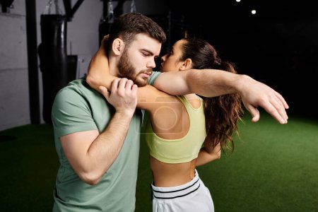 A man and a woman gracefully move in synchrony, demonstrates self-defense techniques