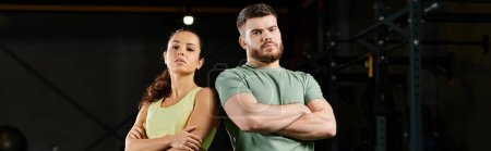 Téléchargez les photos : Un entraîneur masculin enseigne des techniques d'auto-défense à une femme dans une salle de gym. - en image libre de droit