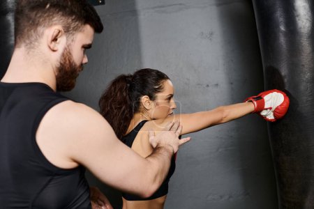 A male trainer coaches a brunette sportswoman, displaying strength and determination.