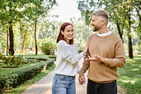 Adult loving couple walking through a peaceful park.