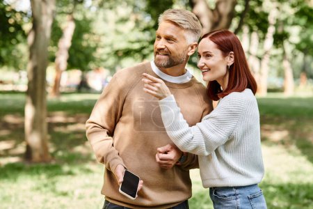Un homme et une femme, un couple amoureux, flânent dans un parc serein.