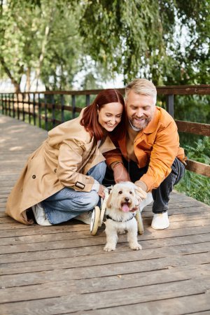 Photo for A loving couple and their furry companion enjoying a peaceful moment on a park bench. - Royalty Free Image