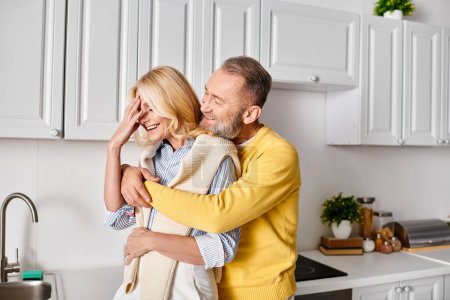 A man tenderly holds a woman in a cozy kitchen setting, sharing a moment of love and connection within the comforts of home.