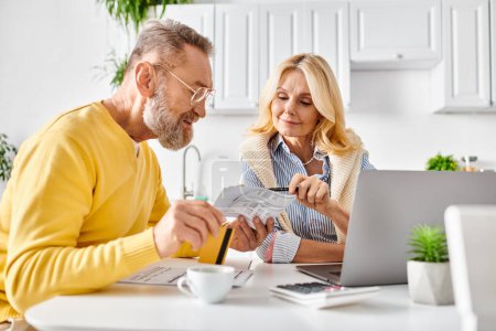 A mature man and woman reading a piece of paper together in their cozy kitchen at home.