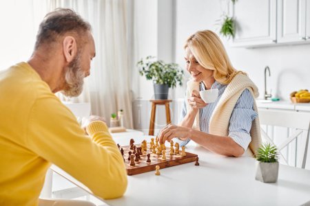 A mature loving couple in cozy homewear engaged in a intense game of chess, strategizing and making calculated moves.