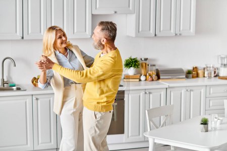 A mature loving couple in cozy homewear dance gracefully in their kitchen, enjoying each others company.