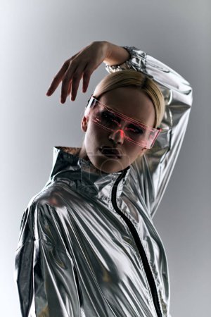peculiar woman with sci fi glasses in futuristic attire doing robotic motions and looking at camera