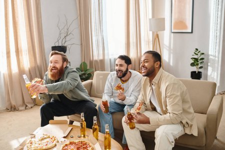 Three cheerful, interracial men having a great time together on a couch, enjoying pizza and beer in a casual setting.
