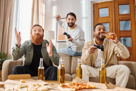 Three handsome, cheerful men of different races sit around a table, enjoying pizza and each others company in a casual setting.