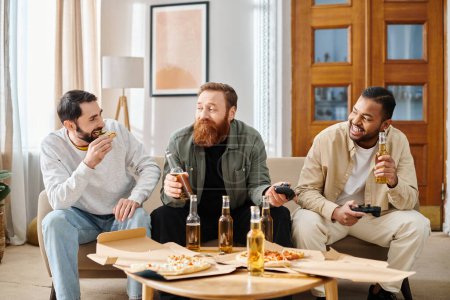 Three cheerful, interracial men in casual attire enjoy pizza and beer while sitting on a couch, symbolizing friendship and camaraderie.