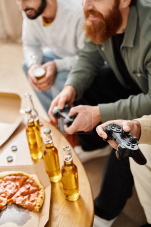 Photo for Two men, from different racial backgrounds, engage in a friendly video game session on a couch in casual clothes, enjoying laughter and camaraderie. - Royalty Free Image