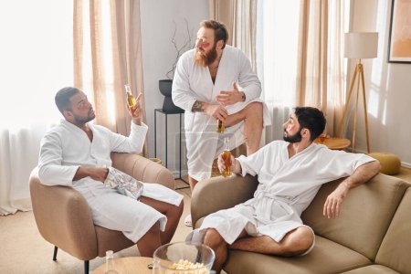 Diverse, cheerful men in bathrobes bond joyfully on top of a couch in a moment of friendship and camaraderie.