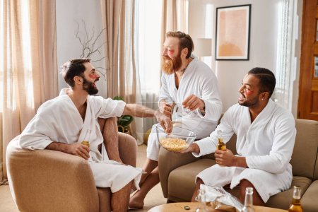 Three cheerful men of diverse backgrounds sit in a living room, enjoying each others company and friendship.