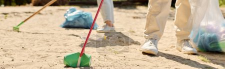 Photo for Multiracial loving couple passionately cleaning up a park while wearing safety gloves. - Royalty Free Image