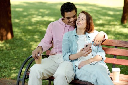 A diverse couple in vibrant attires sitting on a park bench, enjoying each others company on a sunny day.