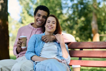 A diverse couple in vibrant attire sits together on a park bench, enjoying each others company in a serene setting.