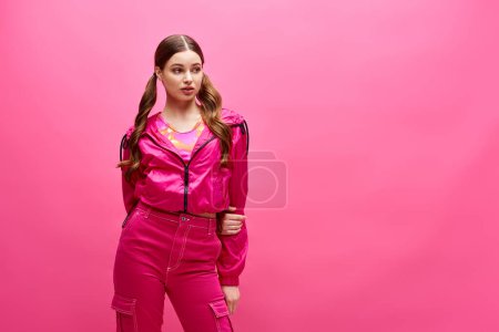 Photo for A stylish woman in her 20s is confidently posing for a portrait in a pink outfit, exuding elegance and beauty. - Royalty Free Image
