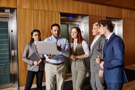 Photo for Diverse group of business people gather in front of elevator. - Royalty Free Image