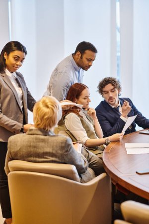 Téléchargez les photos : Multicultural business professionals brainstorming around a conference table. - en image libre de droit