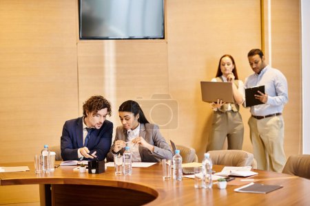 Diverse business professionals engaged in a meeting at a conference table.