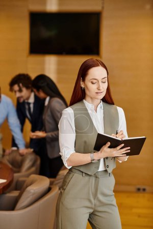 A professional woman holding a folder in a modern lobby.