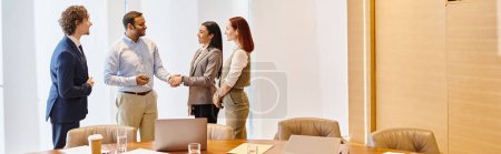 Photo for Multicultural business team discussing strategies around a conference table. - Royalty Free Image