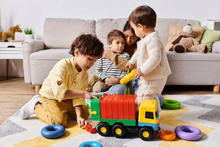 young Asian mother and her little sons, laughing and playing with a toy truck in their living room.