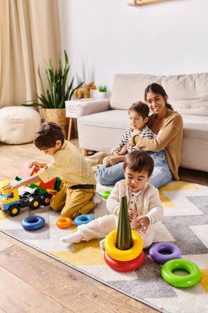 A young Asian mother watches as her little sons play with colorful toys in a warm, inviting living room.