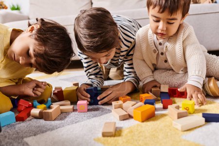 Three young children, likely siblings, engage in imaginative play as they construct with wooden blocks on the living room floor.