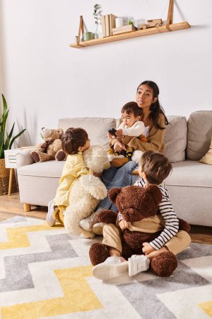 Young Asian mother relaxes on couch surrounded by various stuffed animals while bonding with her little sons in cozy living room.
