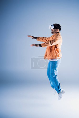 A man in a VR headset jumps energetically in a studio setting, showcasing his acrobatic skills while wearing a stylish hat.