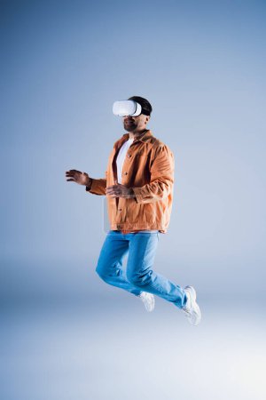 A man with a hat jumps in the air within a studio setting while wearing a VR headset for metaverse exploration.