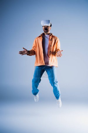 A man in a vibrant orange jacket is caught mid-air, showcasing his energetic leap in a studio setting.