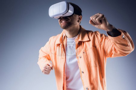 A stylish man in an orange shirt and white vr poses in a vibrant blue setting.