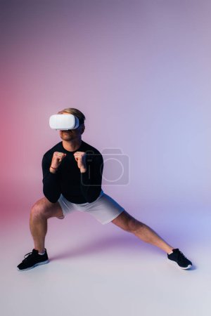 Photo for A man in a black shirt and white shorts stands confidently in a studio setting, exuding a sense of mystery and strength. - Royalty Free Image