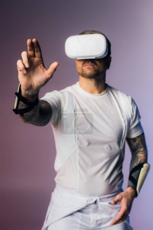 A man in a white shirt is fully engaged, wearing a virtual reality headset in a studio setting.