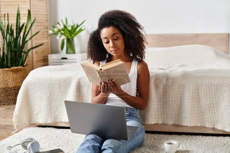 An African American woman with curly hair is sitting on the floor in a modern bedroom, deeply engrossed in reading a book.