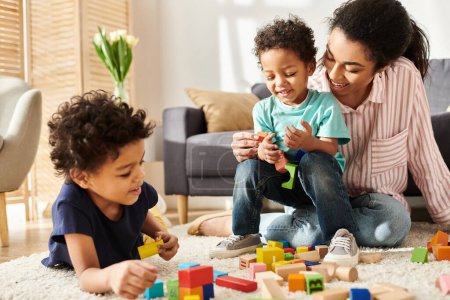 attractive african american woman playing actively with her little cute sons while at home
