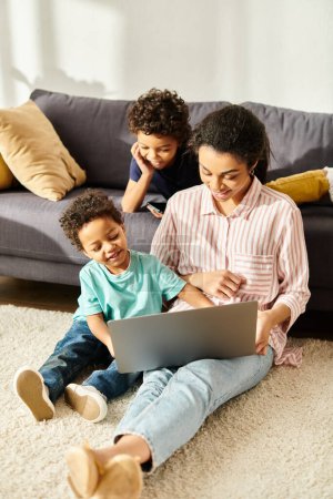 cheerful african american woman in cozy attire watching movies with her adorable sons at home