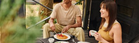 Foto de An interracial couple enjoying a meal together at a table filled with delicious food, sharing a romantic moment in a camper van. - Imagen libre de derechos