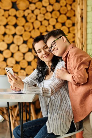 cheerful boy with Down syndrome spending time with his beautiful mother in cafe with phone and menu