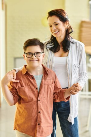 Photo for Happy preteen inclusive boy with Down syndrome posing with his merry mother and smiling at camera - Royalty Free Image
