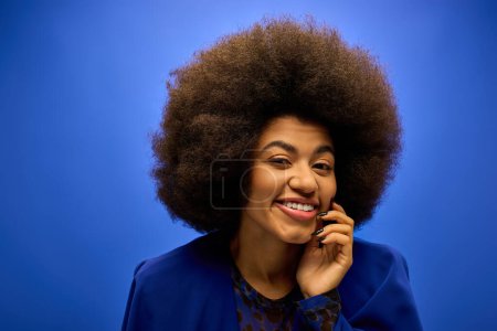 Photo for Trendy African American woman with curly hairdo talking on cell phone. - Royalty Free Image
