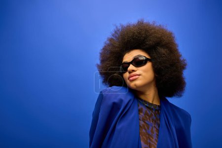 Stylish African American woman in trendy attire, posing on a vibrant backdrop.