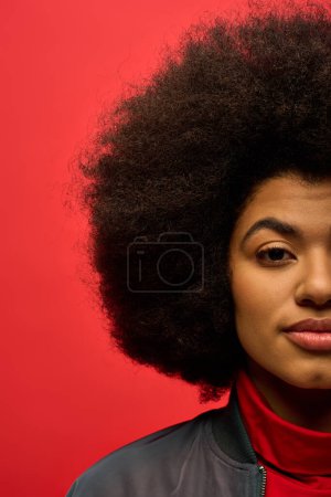 Photo for Stylish African American woman with curly hairdoin red shirt. - Royalty Free Image